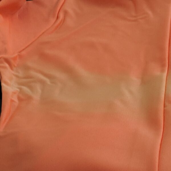 Example of the faded colour in the Fluorescent Orange catsuits